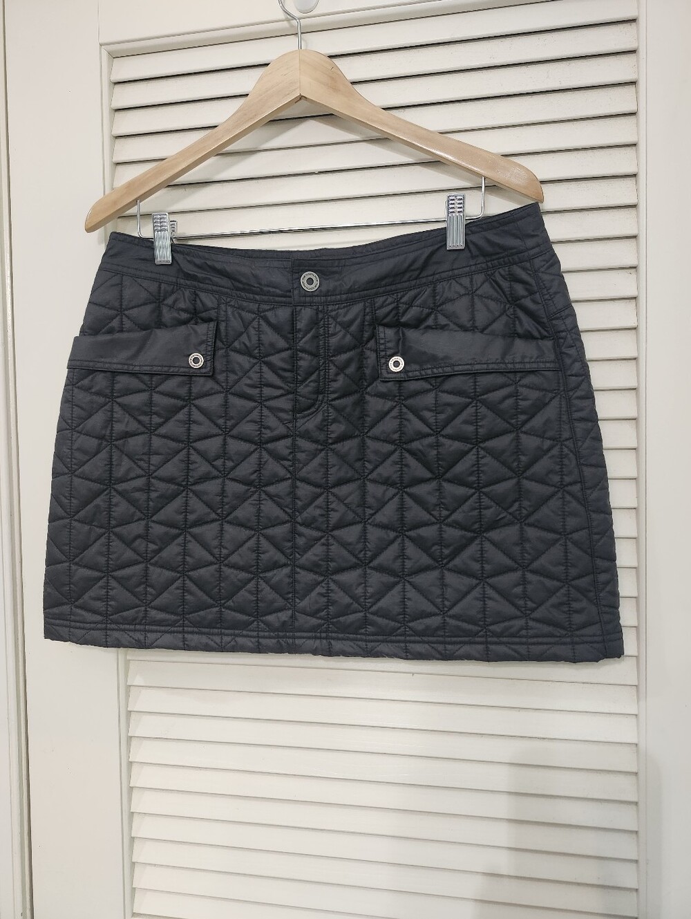The North Face Black Quilted Mini Skirt with Front Flap Pockets